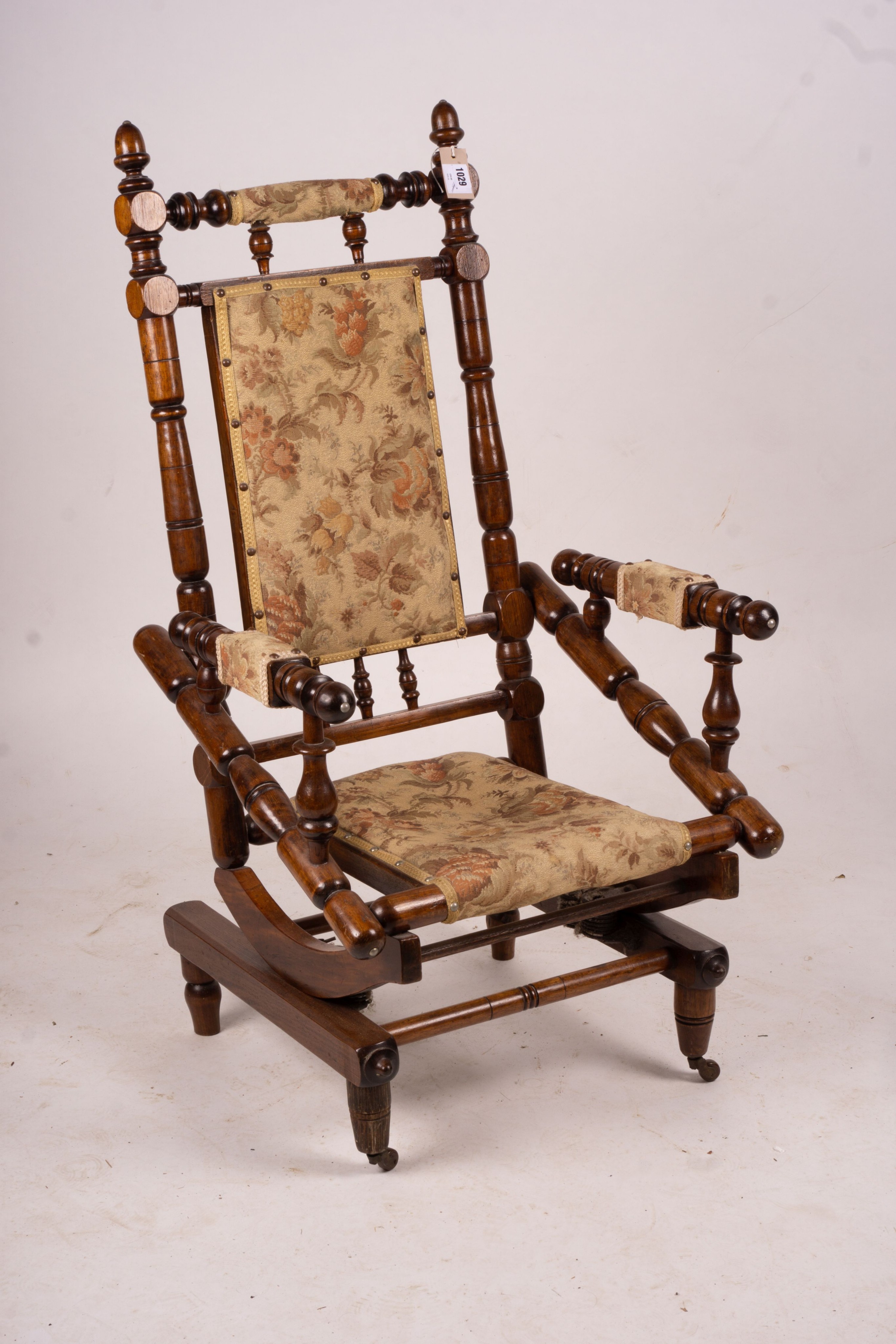 An early 20th century American turned mahogany rocking chair